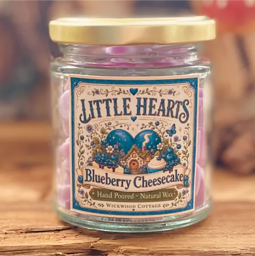 Close-up of a Little Hearts Blueberry Cheesecake wax melt jar with a whimsical vintage-style label and lilac wax melts inside.