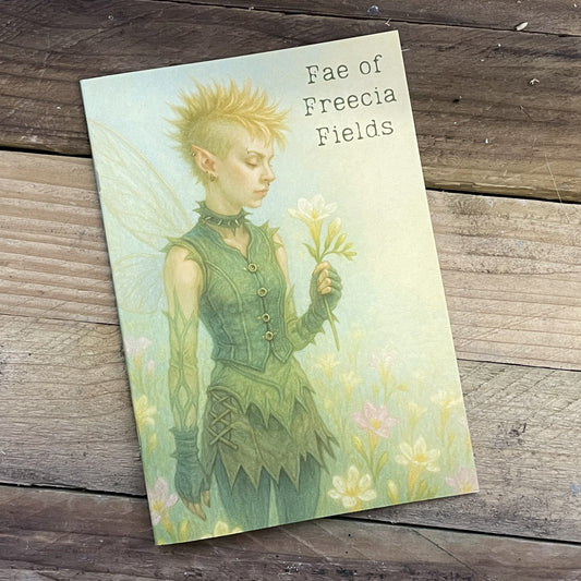 Notebook with a fairy illustration on a wooden surface