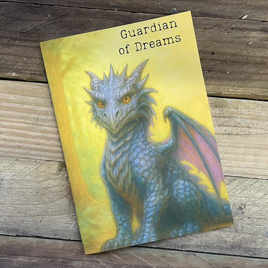 Book cover with a dragon illustration titled 'Guardian of Dreams' on a wooden surface