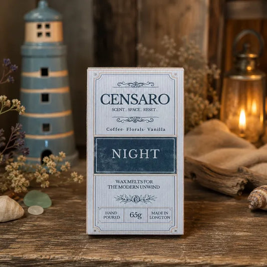 A box of Censaro 'Night' scented waxmelt stands on a rustic wooden surface. The packaging is a light blue-gray with dark blue and beige text and decorative borders.