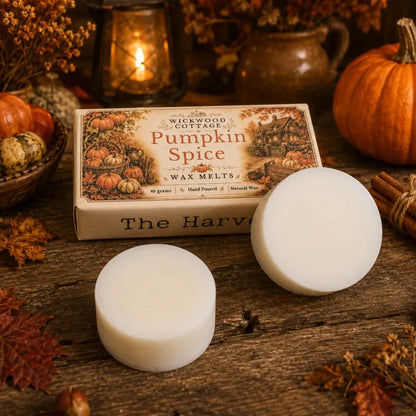 “Wickwood Cottage Pumpkin Spice wax melts with two white wax discs, styled with pumpkins, autumn foliage, cinnamon and warm cottage lantern light.”