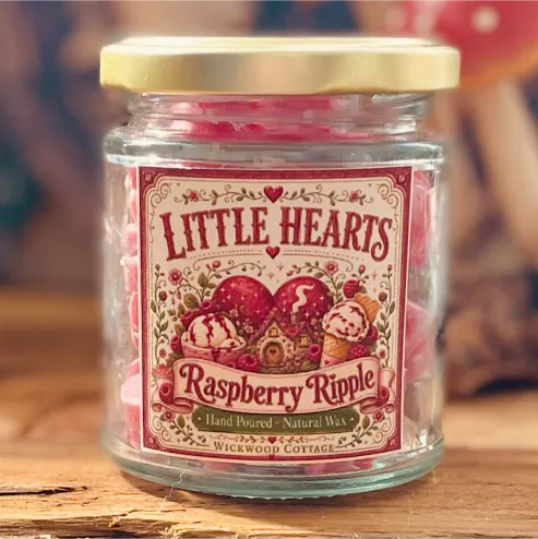 Close-up of a Little Hearts Raspberry Ripple wax melt jar with a whimsical vintage-style label and pink wax melts inside.