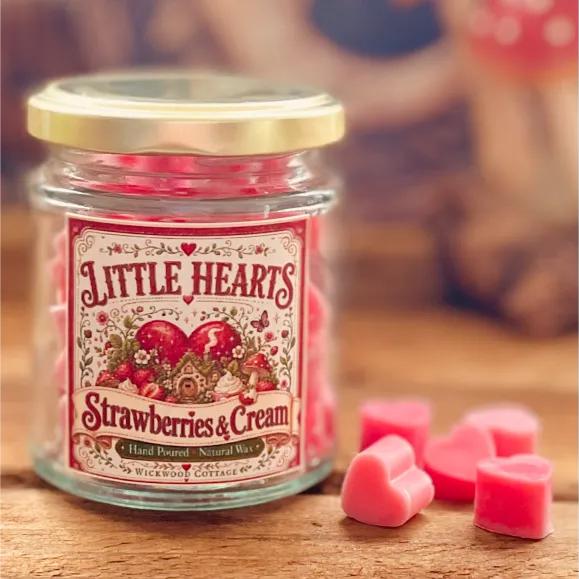 Little Hearts Strawberries and Cream wax melt jar with pink heart and heart-shaped melts displayed on a rustic wooden surface.
