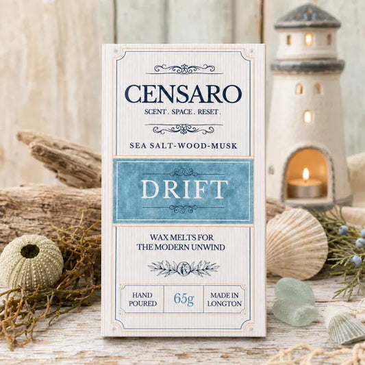 A wrapped scented wax melt from Wickwood Cottage, specifically the 'Drift' scent. The packaging is cream-colored with navy blue and light blue accents.