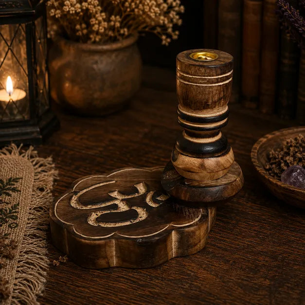 Wooden Om backflow incense burner with carved detailing and natural brown finish, standing on a rustic table with a glowing lantern in the background.