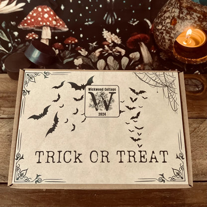 Halloween-themed trick or treat wax melt gift box with bats and 'Trick or Treat' text on a wooden surface.